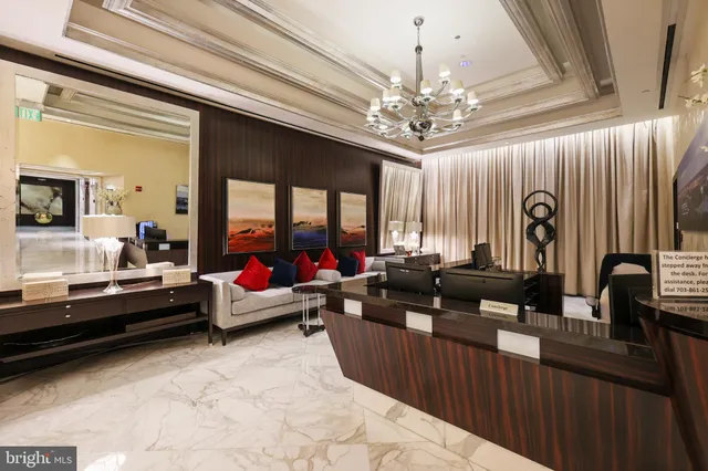 a living room with furniture a piano and a potted plant