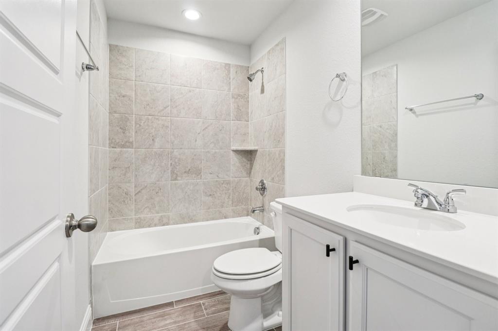 6000 Bursey Road Watauga, TX 76148 - Photo 11 of 13 a bathroom with a sink a toilet and a bathtub