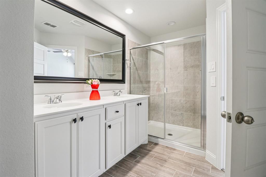 6000 Bursey Road Watauga, TX 76148 - Photo 7 of 13 a bathroom with a sink mirror and shower