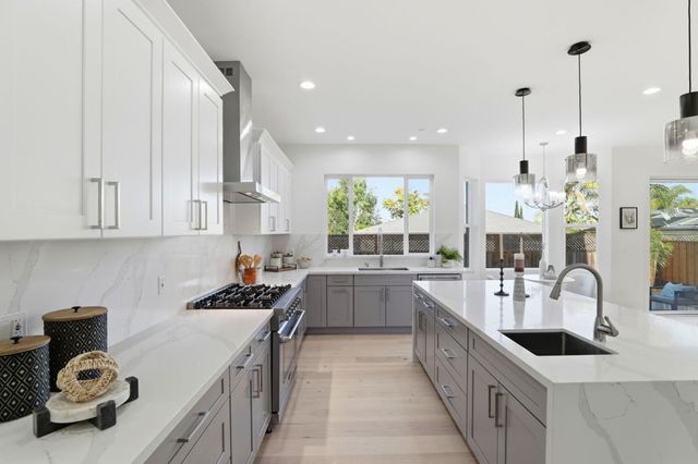 a bathroom with a granite countertop toilet sink and mirror
