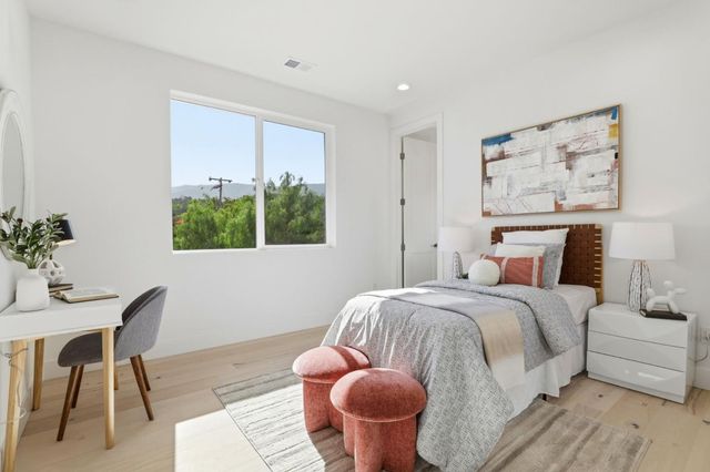 an aerial view of a house with a yard and a large tree