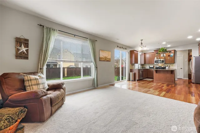 a bedroom with a bed and lamp on dresser