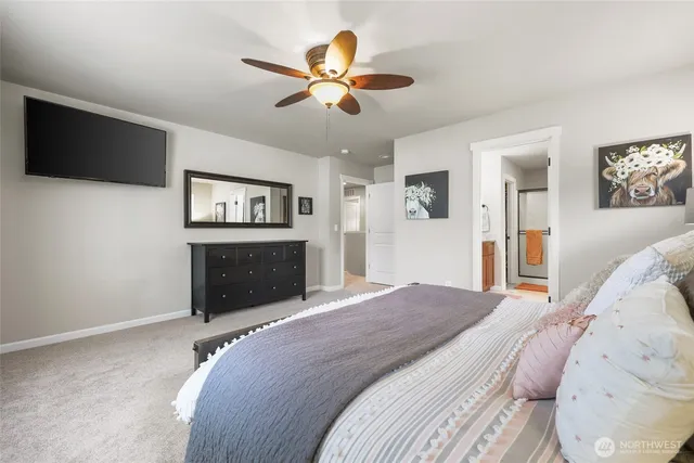 a view of an empty room with a ceiling fan