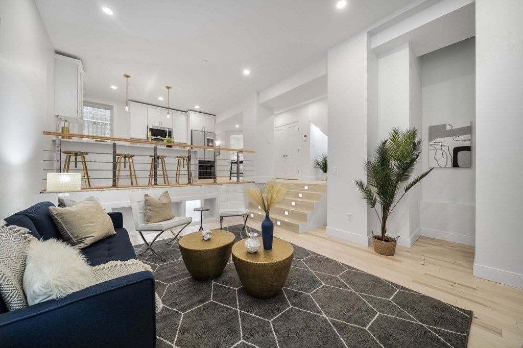 a living room with furniture and a potted plant