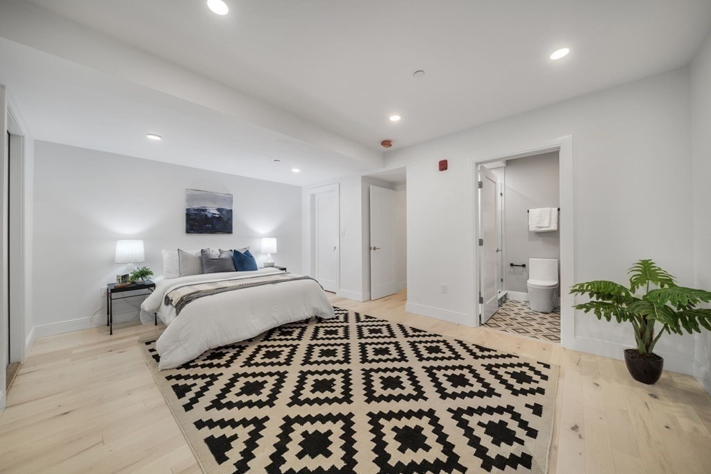 340 Meridian Street, Unit 1 Boston, MA 02128 - Photo 14 of 24 a bedroom with bed and a potted plant