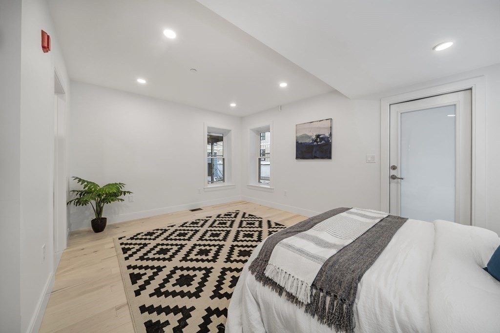 340 Meridian Street, Unit 1 Boston, MA 02128 - Photo 15 of 24 a bedroom with a large bed and a potted plant