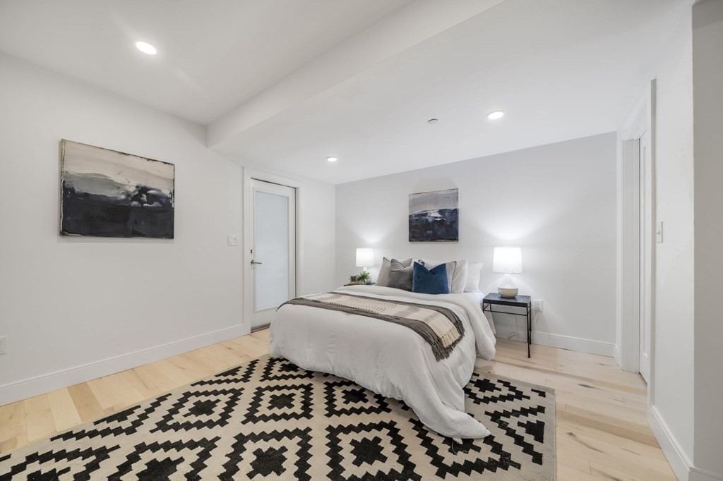 340 Meridian Street, Unit 1 Boston, MA 02128 - Photo 16 of 24 a bedroom with a bed and a flat screen tv