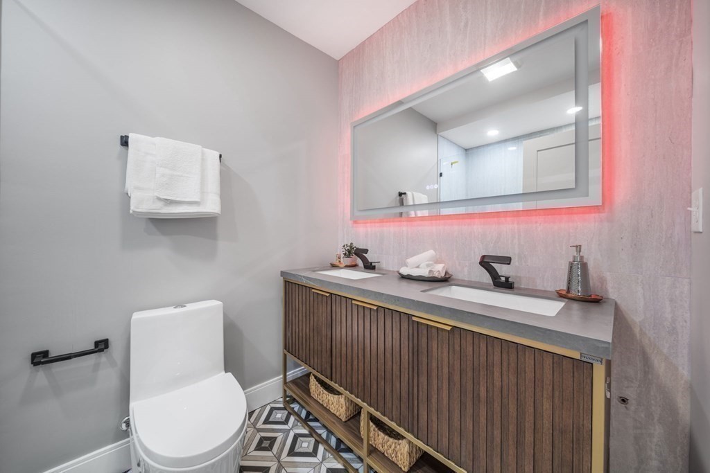 340 Meridian Street, Unit 1 Boston, MA 02128 - Photo 17 of 24 a bathroom with a toilet a sink and mirror