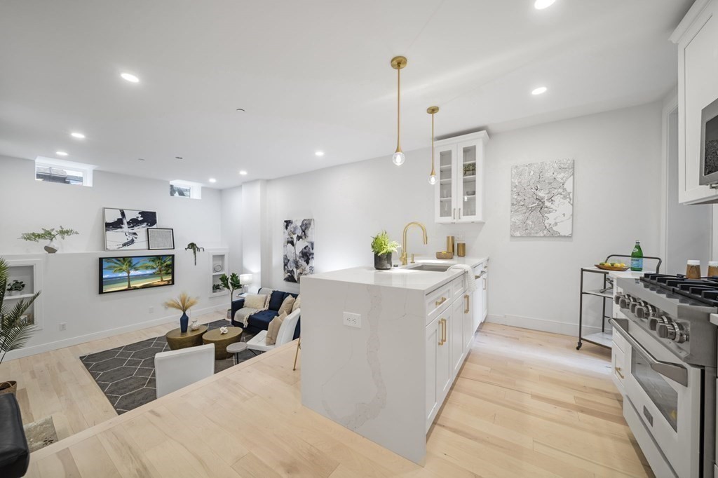 340 Meridian Street, Unit 1 Boston, MA 02128 - Photo 3 of 24 a large white kitchen with stainless steel appliances