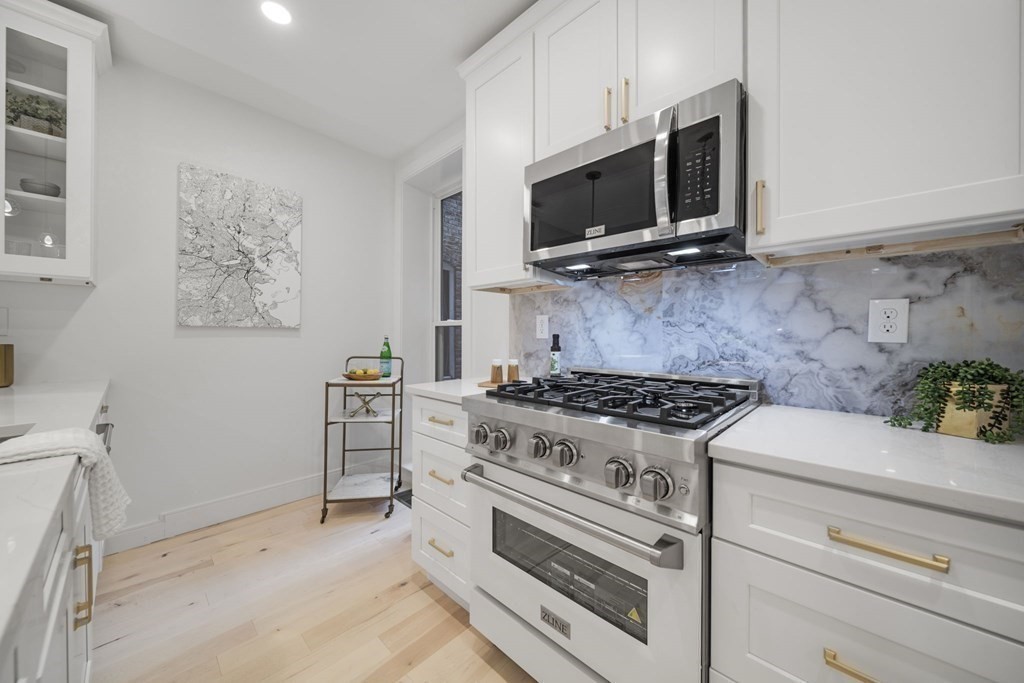340 Meridian Street, Unit 1 Boston, MA 02128 - Photo 7 of 24 a kitchen with a stove and a microwave