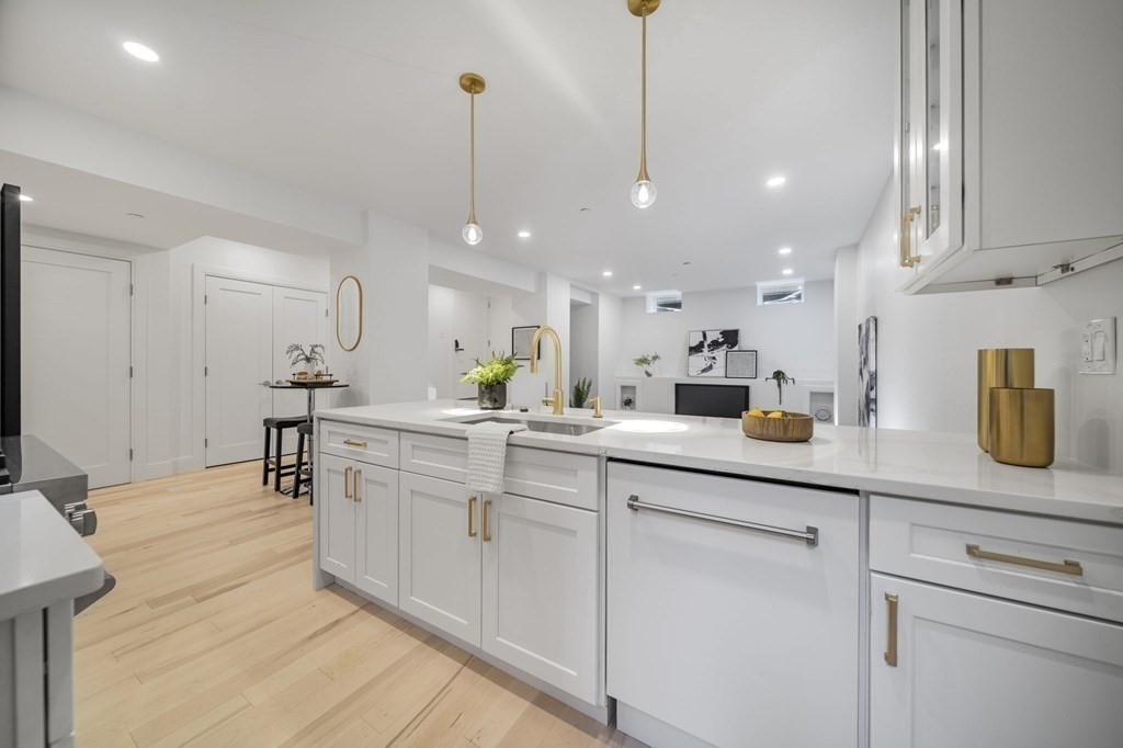 340 Meridian Street, Unit 1 Boston, MA 02128 - Photo 8 of 24 a kitchen with white cabinets and sink