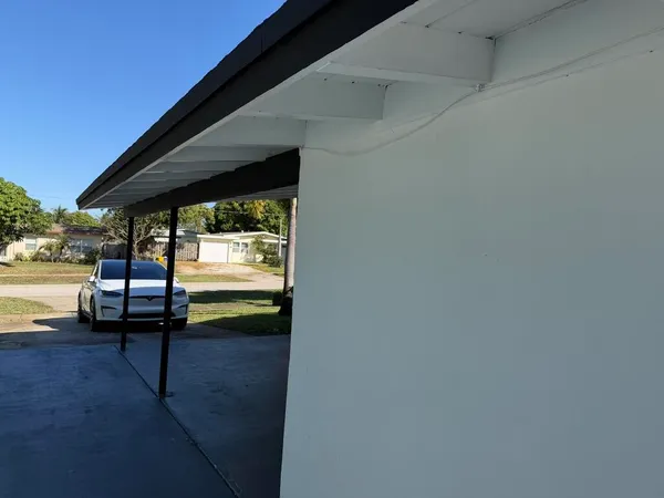 a backyard of a house with barbeque oven table and chairs