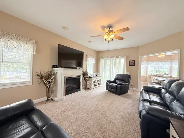a living room with furniture a fireplace and a flat screen tv