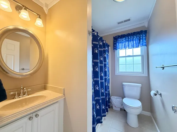 a bathroom with a toilet a sink and a mirror