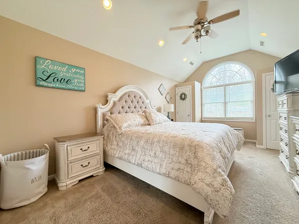 a spacious bedroom with a bed and a large window