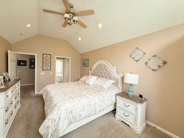 a bedroom with a bed and chandelier