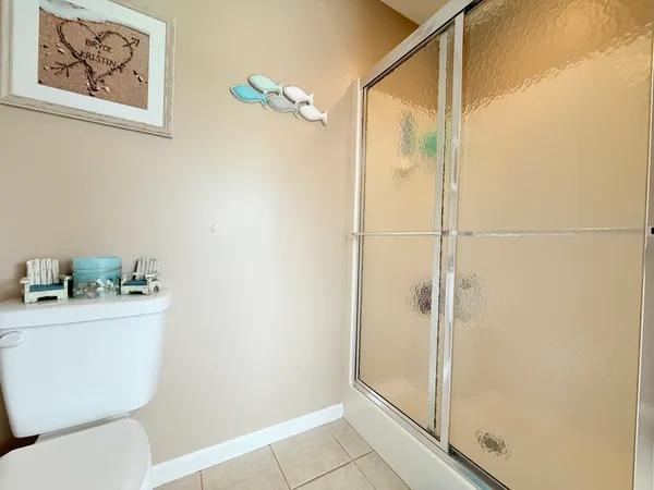 a bathroom with a toilet a sink and shower