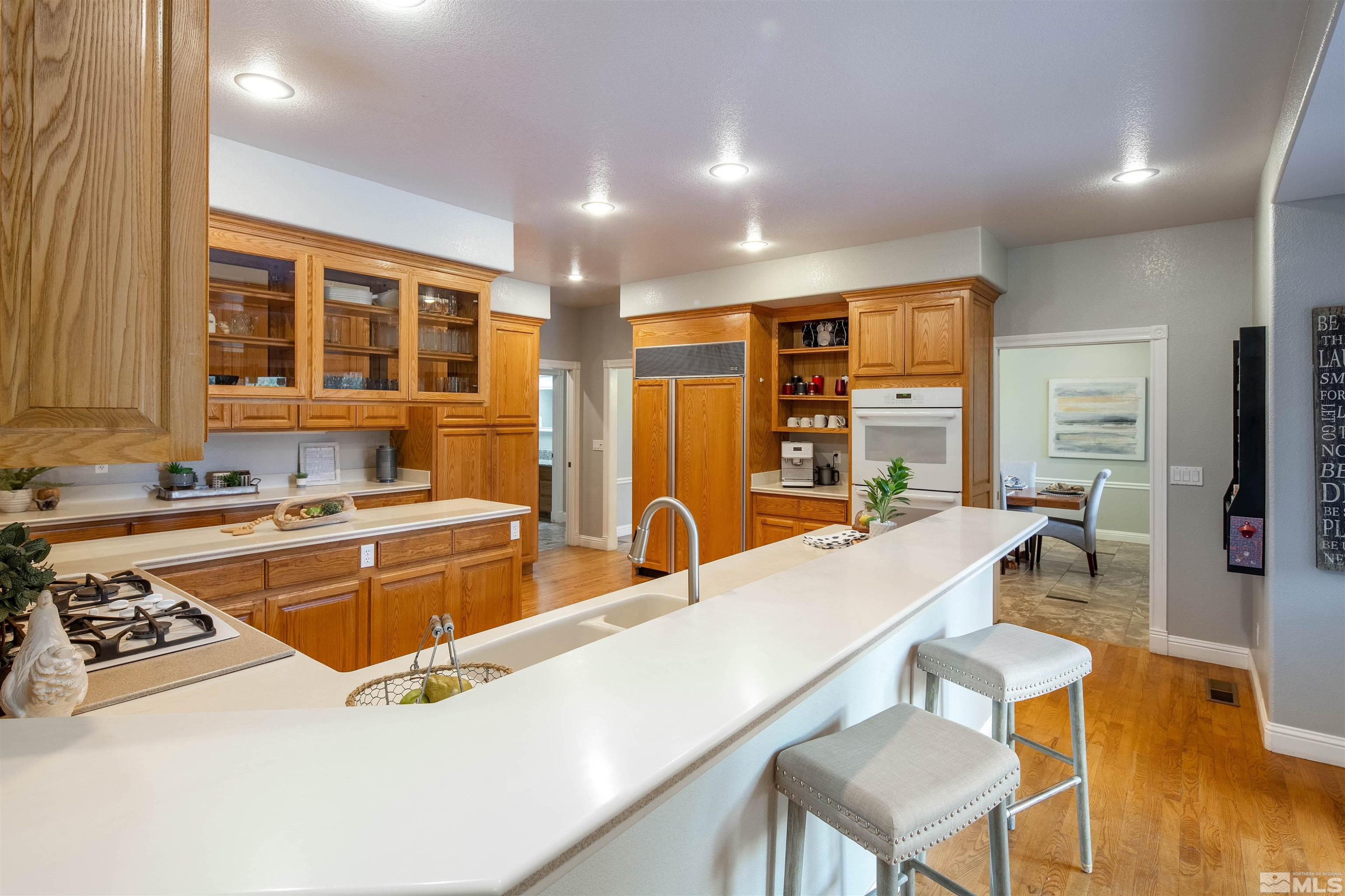 2032 Ash Canyon Road Carson City, NV 89703 - Photo 17 of 37 a large kitchen with kitchen island a stove a sink and a refrigerator