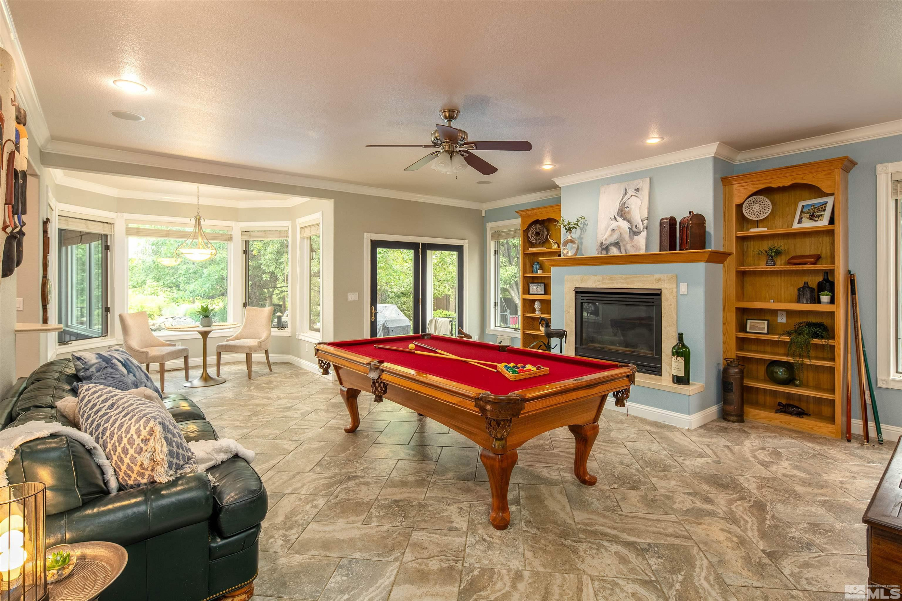 2032 Ash Canyon Road Carson City, NV 89703 - Photo 19 of 37 a living room with furniture a flat screen tv and a fireplace
