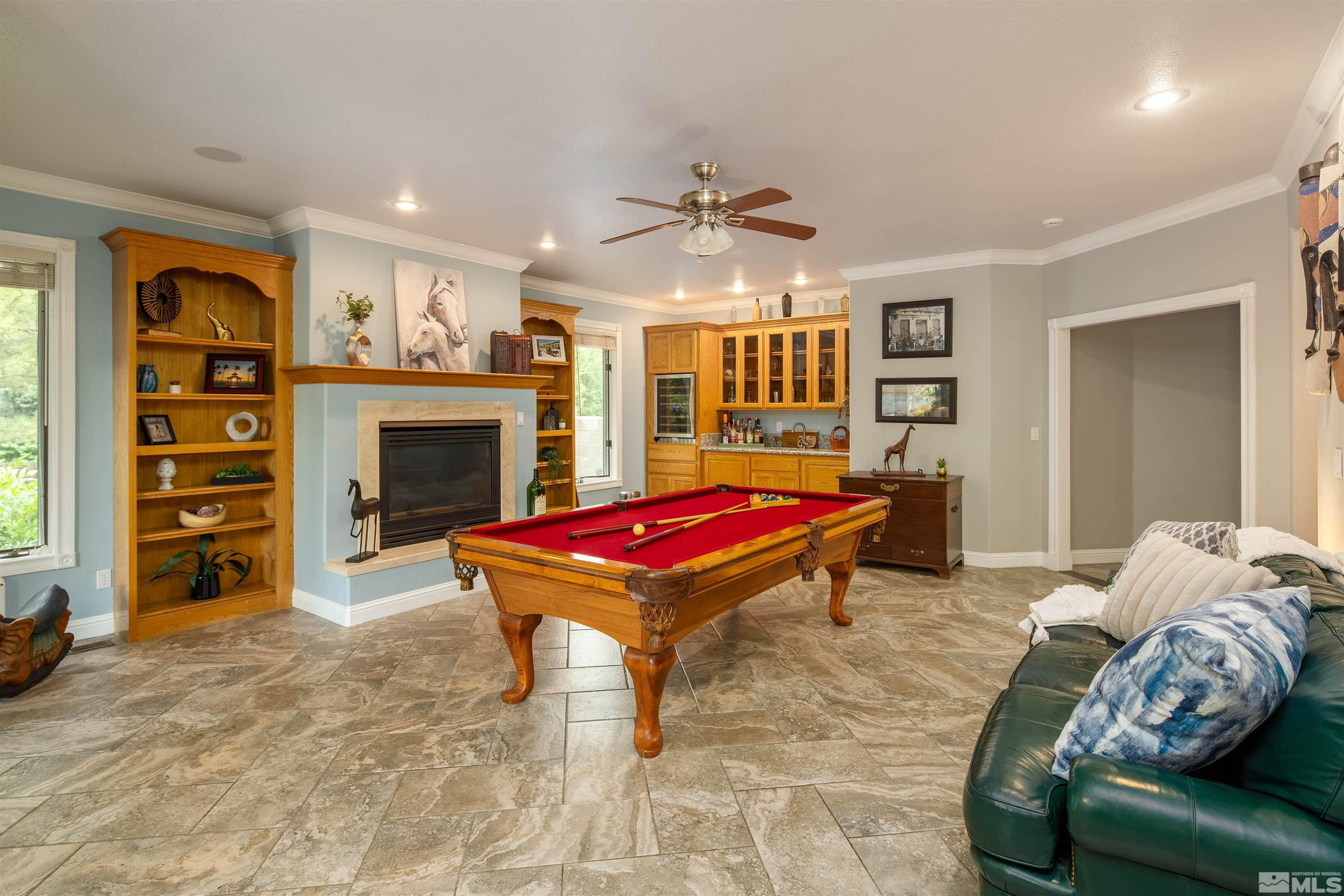 2032 Ash Canyon Road Carson City, NV 89703 - Photo 20 of 37 a living room with furniture a flat screen tv and a fireplace