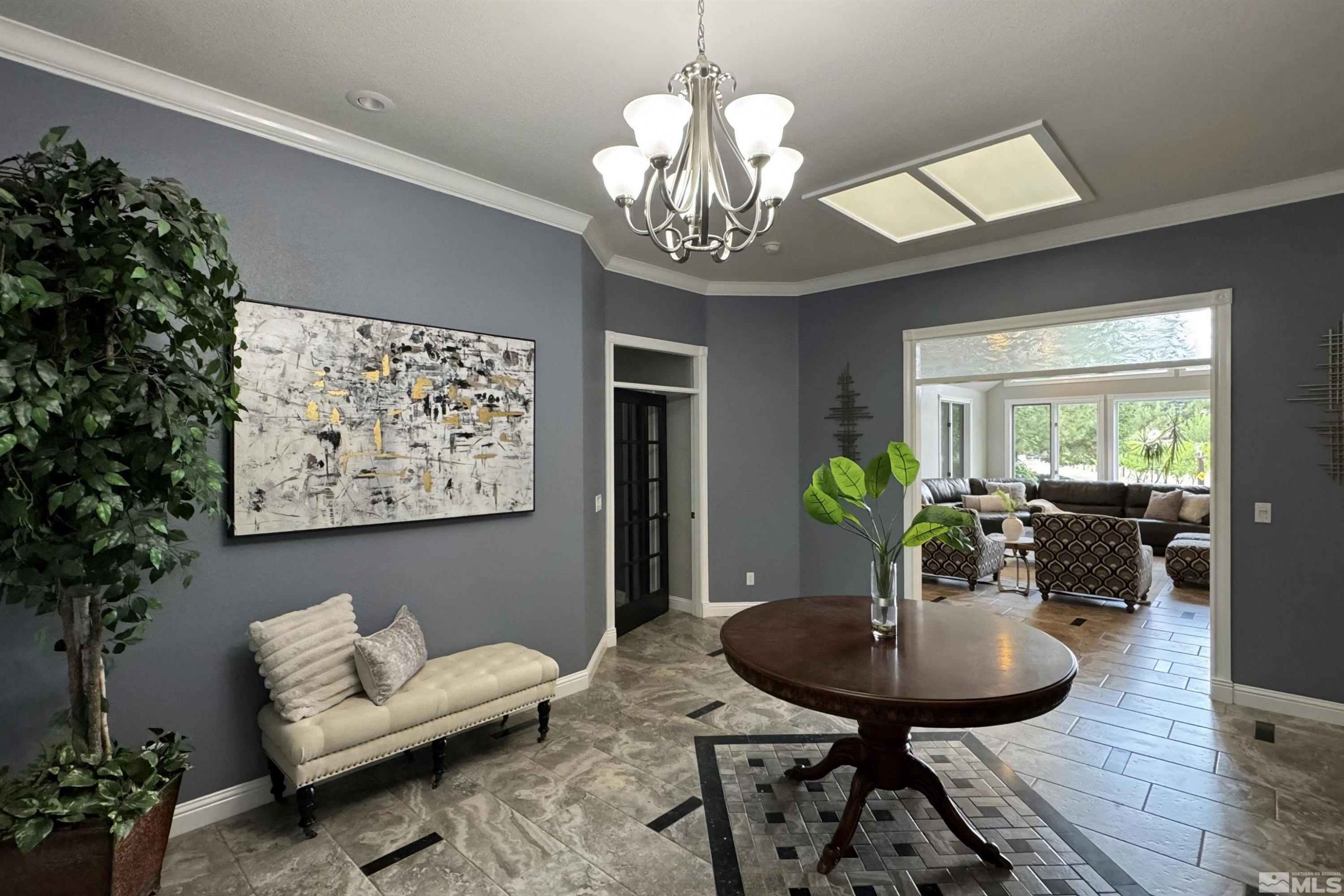 2032 Ash Canyon Road Carson City, NV 89703 - Photo 2 of 37 a living room with furniture a chandelier and a dining room