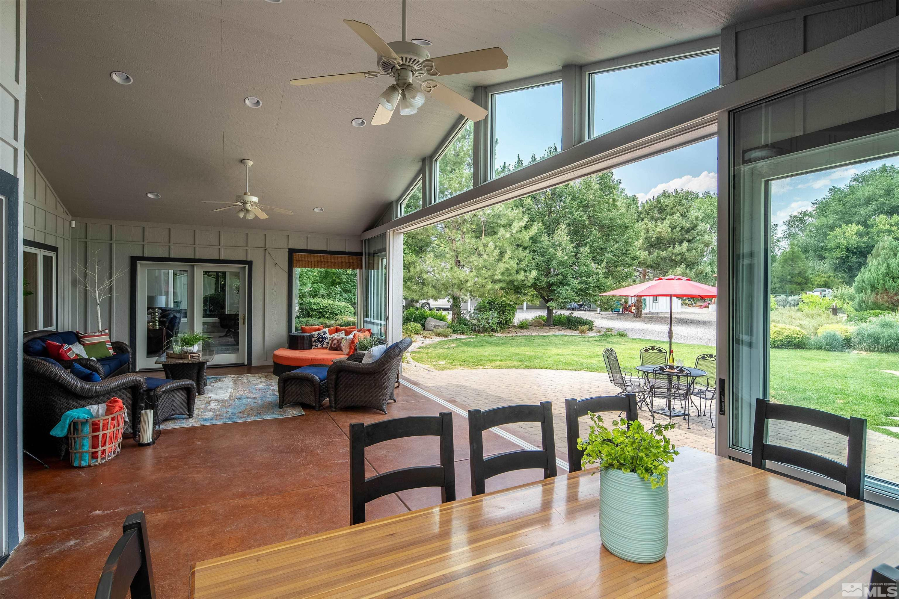 2032 Ash Canyon Road Carson City, NV 89703 - Photo 21 of 37 a living room filled with furniture and a garden