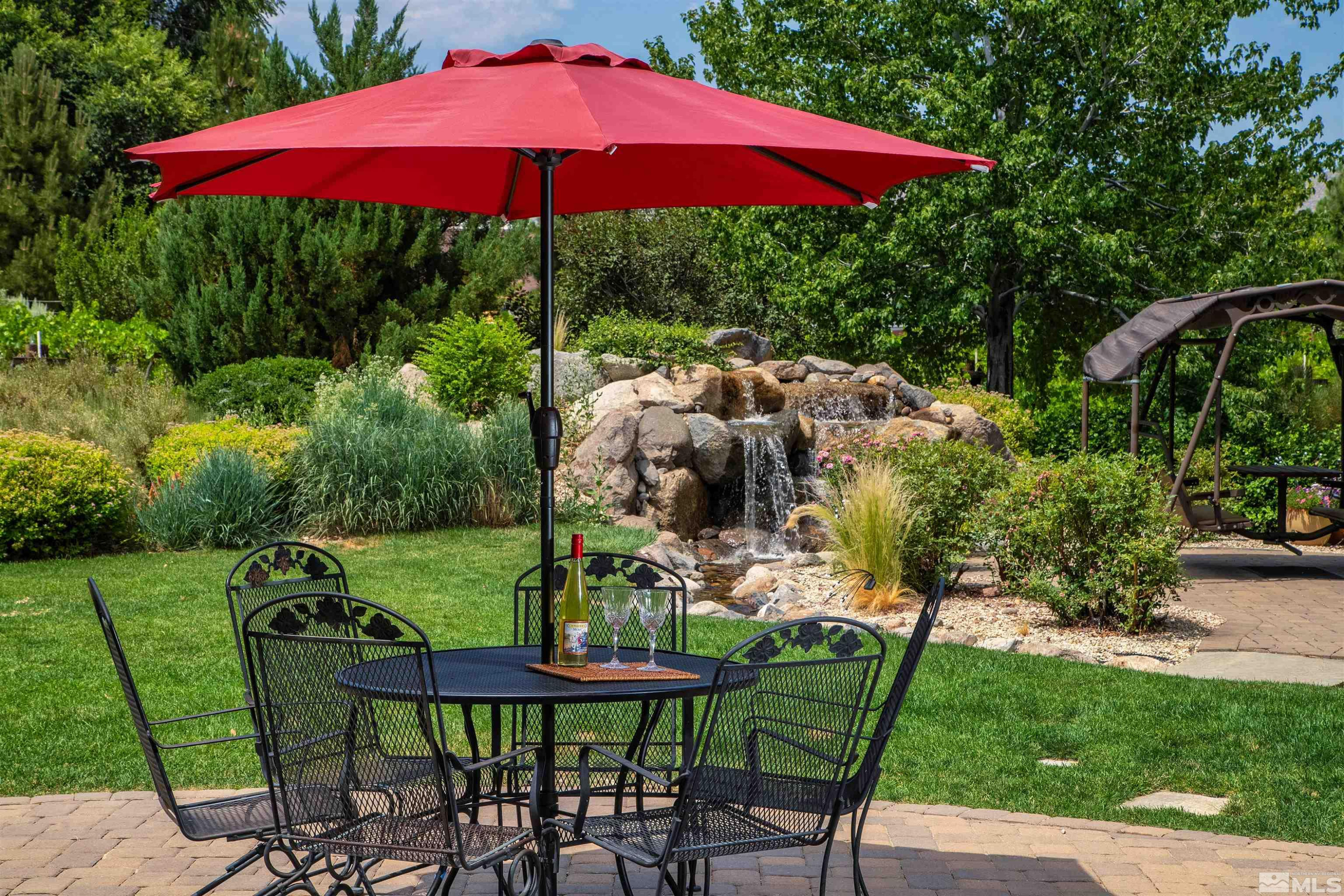 2032 Ash Canyon Road Carson City, NV 89703 - Photo 24 of 37 a view of a backyard with furniture and a garden