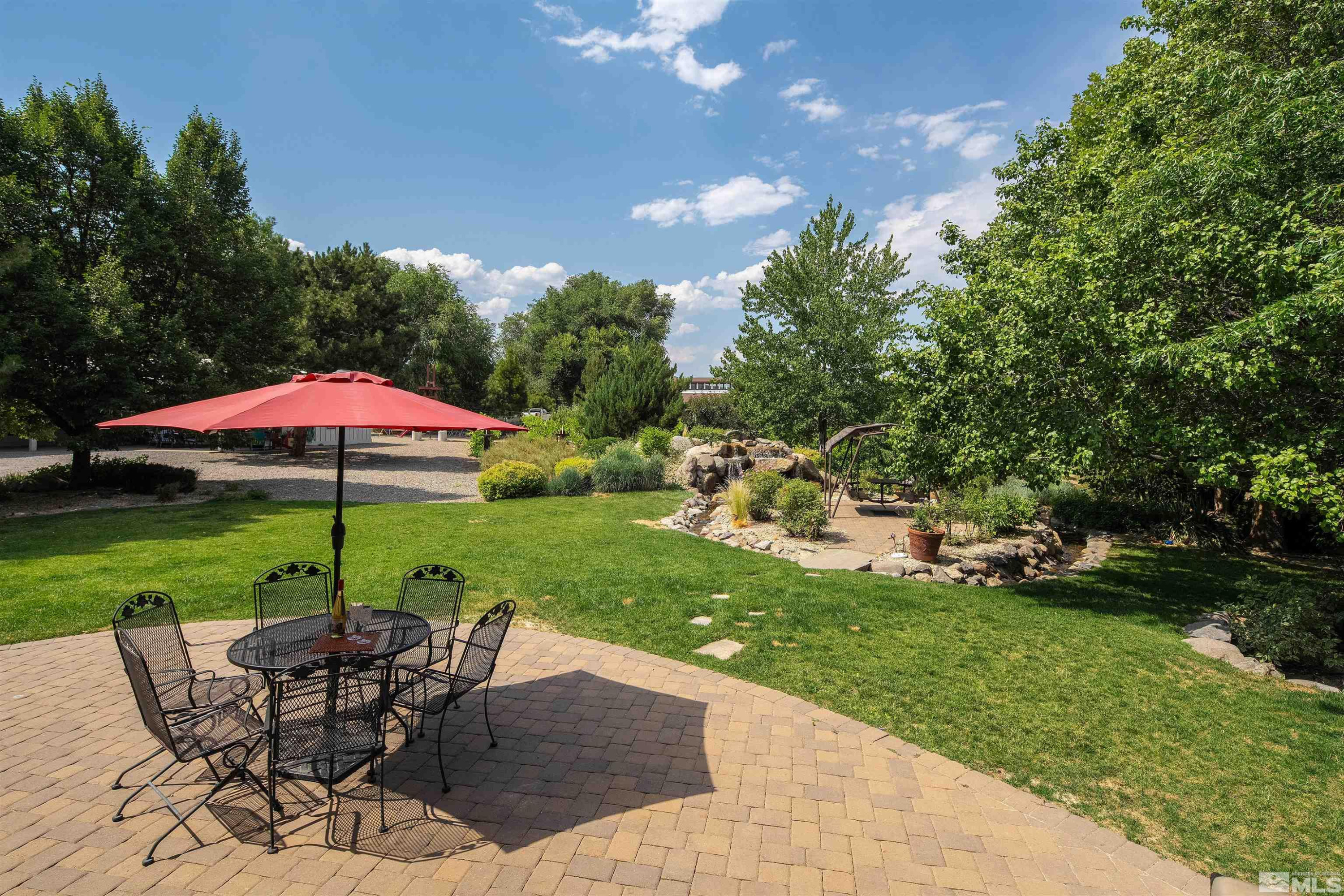 2032 Ash Canyon Road Carson City, NV 89703 - Photo 25 of 37 a view of a table and chairs under an umbrella