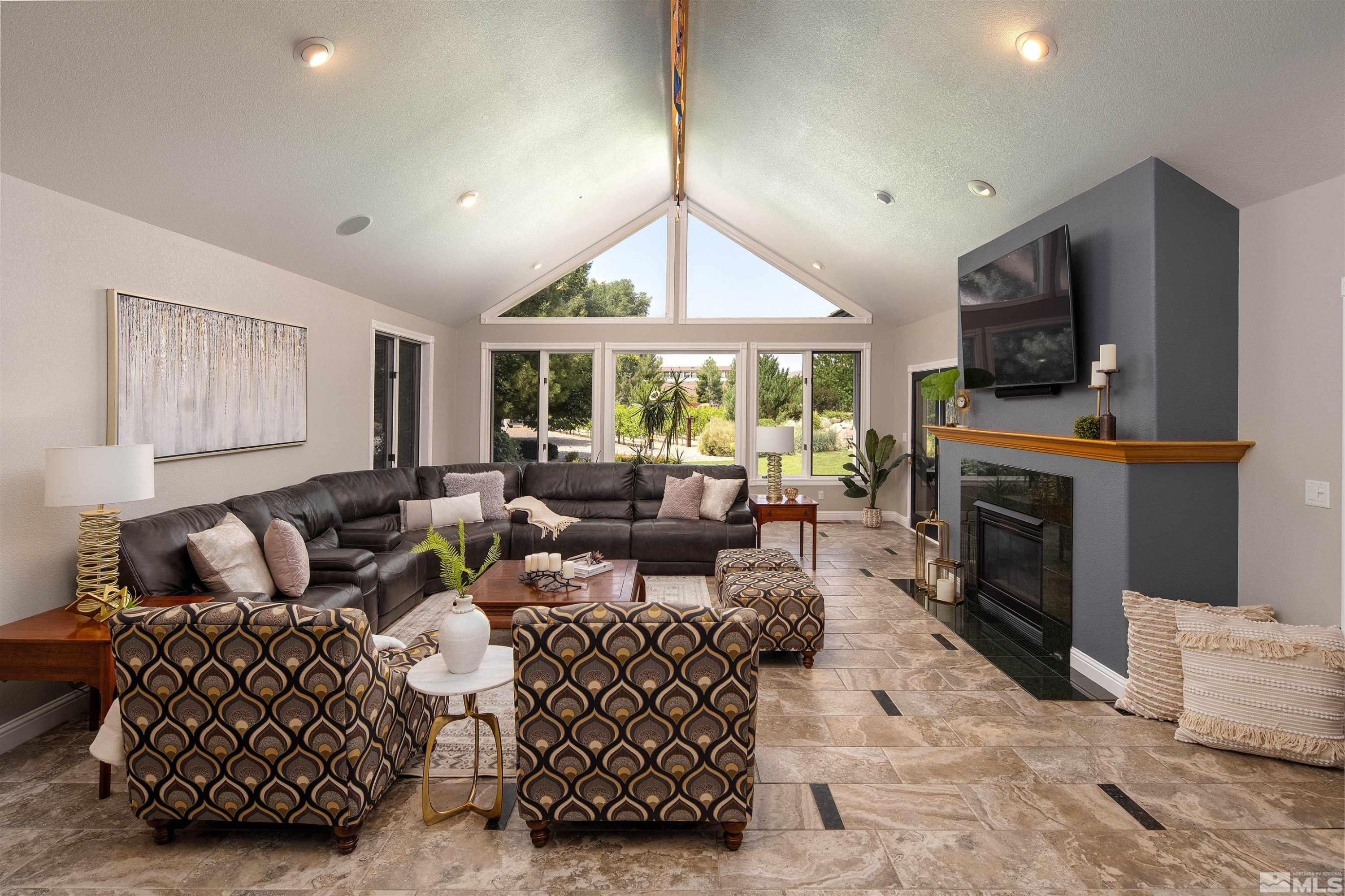2032 Ash Canyon Road Carson City, NV 89703 - Photo 3 of 37 a living room with furniture a fireplace and a flat screen tv