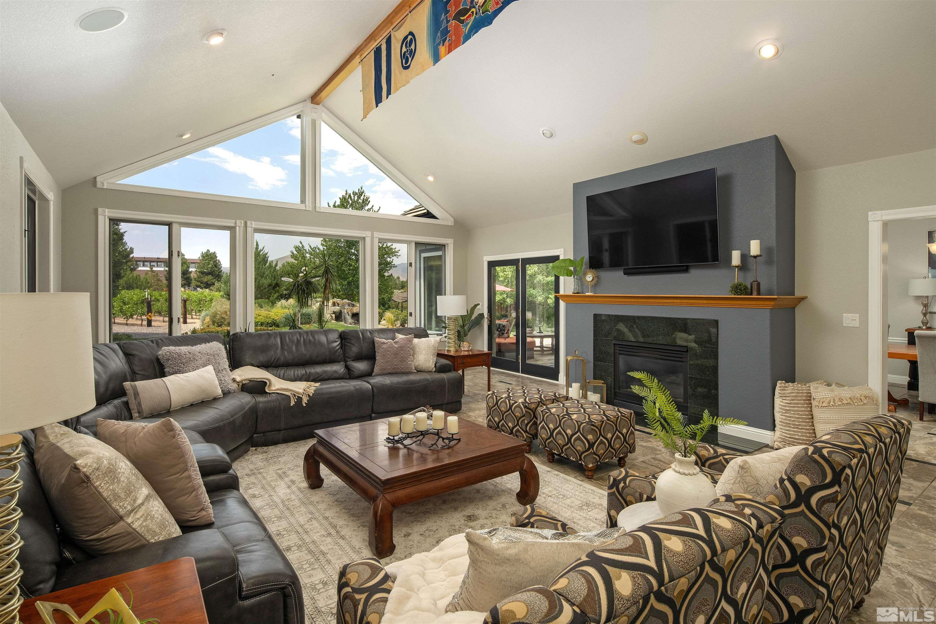 2032 Ash Canyon Road Carson City, NV 89703 - Photo 4 of 37 a living room with furniture large window and a fireplace
