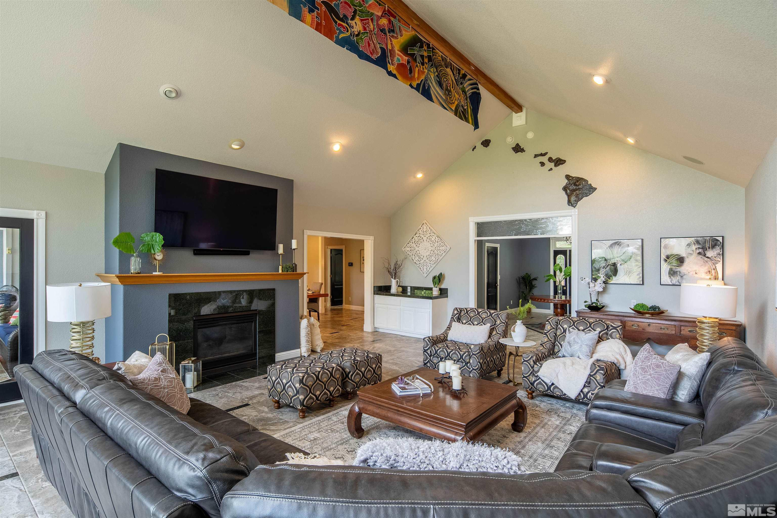 2032 Ash Canyon Road Carson City, NV 89703 - Photo 5 of 37 a living room with furniture a flat screen tv and a fireplace