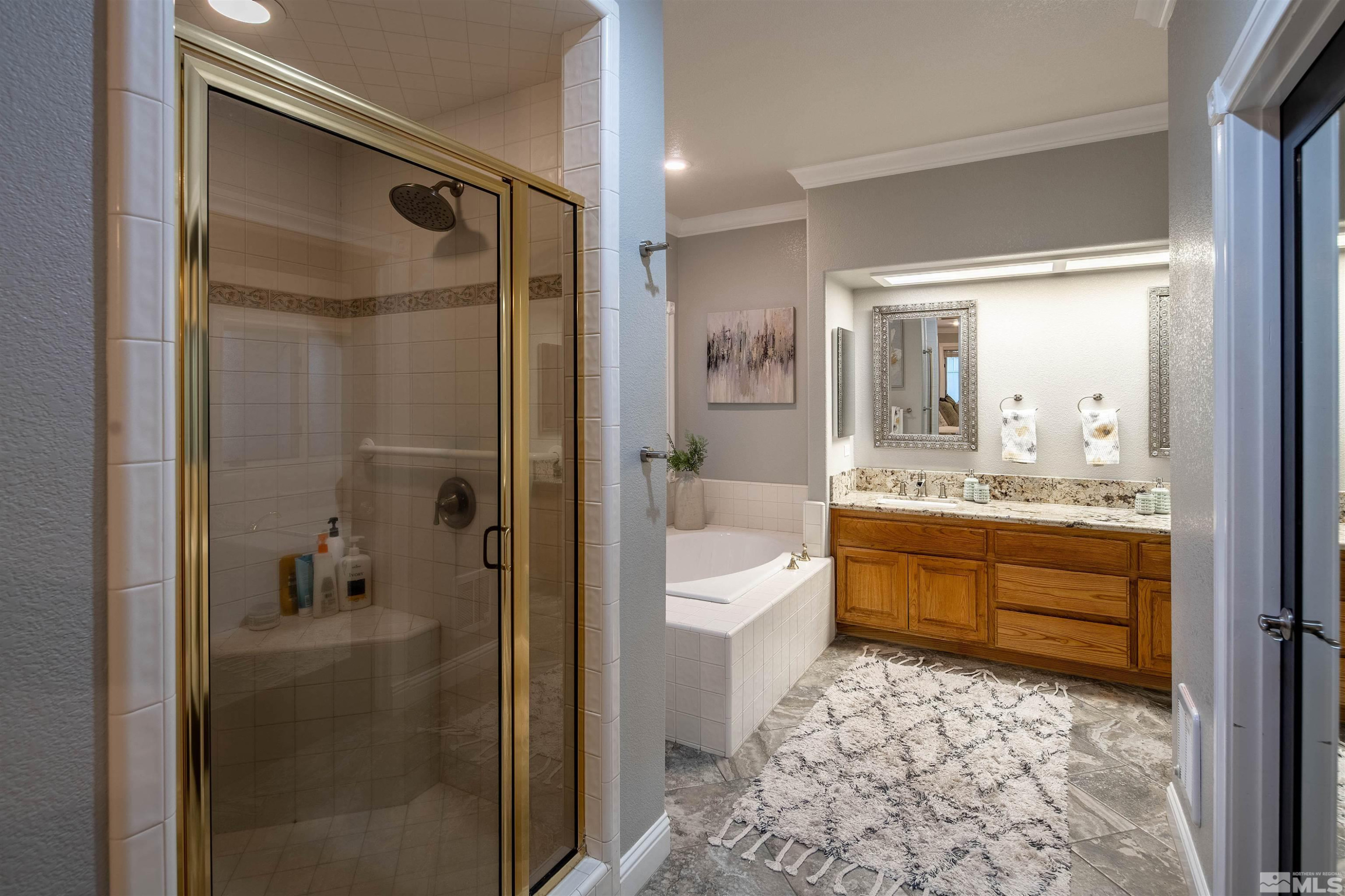 2032 Ash Canyon Road Carson City, NV 89703 - Photo 8 of 37 a bathroom with a double vanity sink toilet mirror and shower