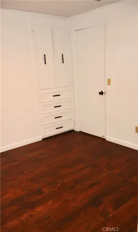 an empty room with wooden floor
