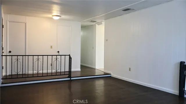 a view of a room with wooden floor