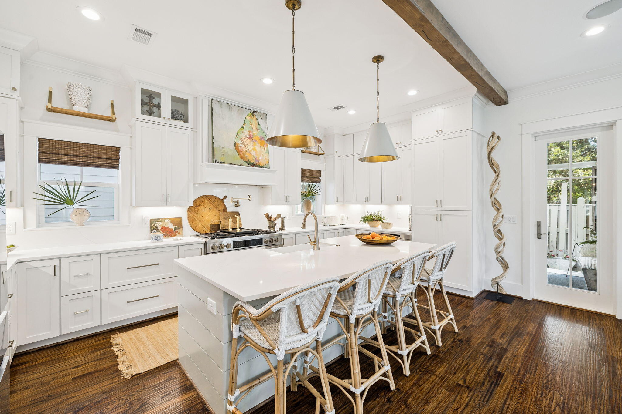 93 Eastern Lake Court Santa Rosa Beach, FL 32459 - Photo 23 of 56 a kitchen with stainless steel appliances a stove a sink a dining table and chairs with wooden floor
