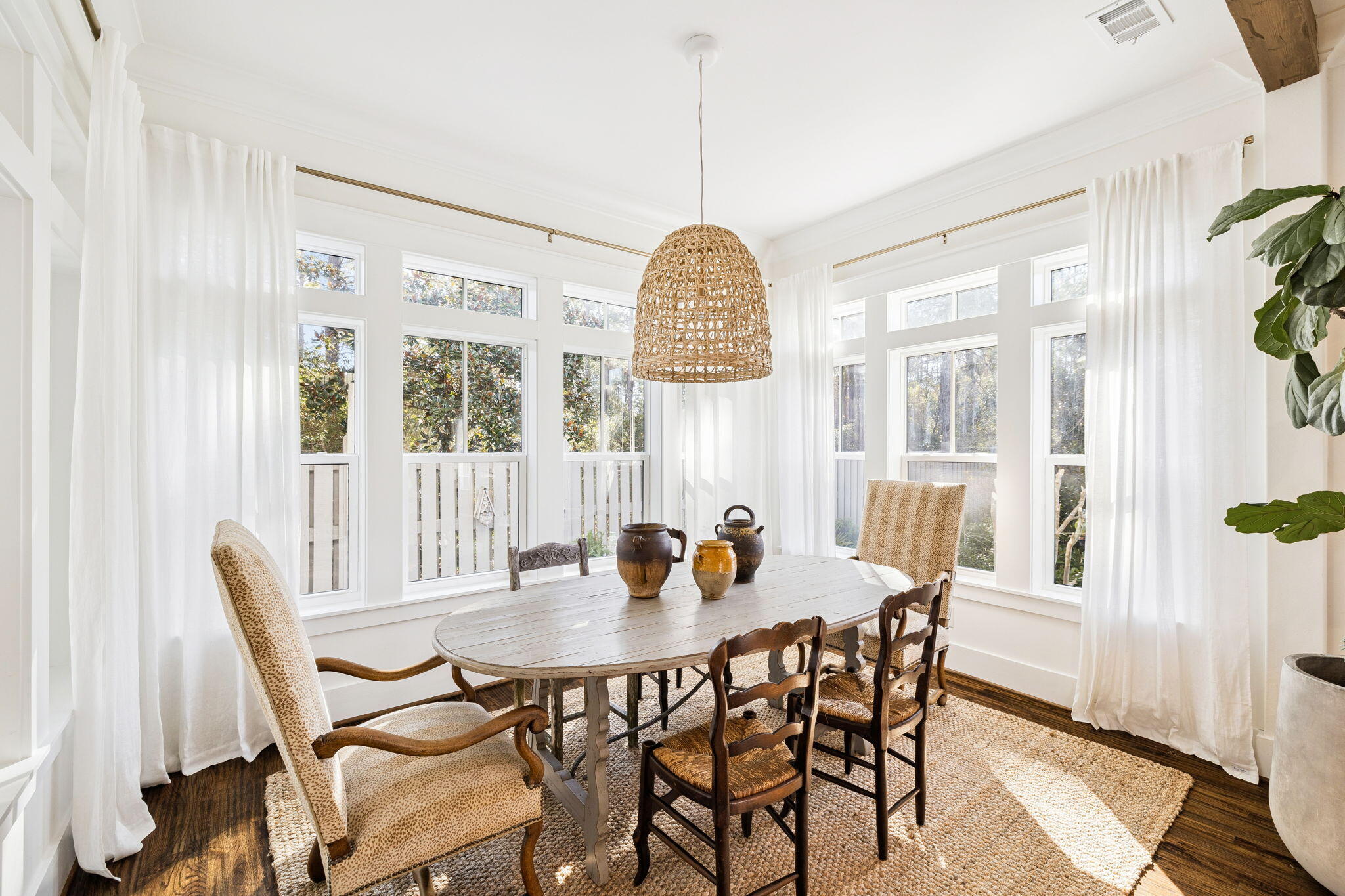 93 Eastern Lake Court Santa Rosa Beach, FL 32459 - Photo 36 of 56 a dining room with furniture a chandelier and wooden floor