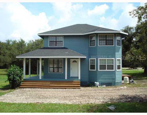 6290 Harney Road Bartow, FL 33830 - Photo 1 of 1 a front view of a house with garden