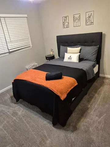 a bedroom with a bed and window