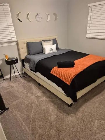 a bedroom with a bed and a window