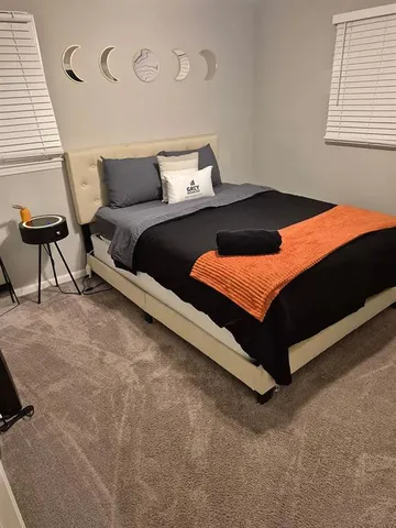 a bedroom with a bed and a window