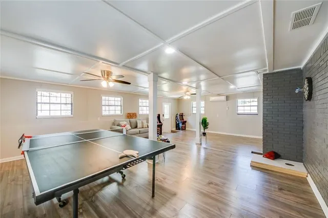 a room with pool table and windows