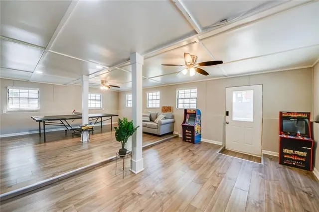 a living room with furniture and a wooden floor
