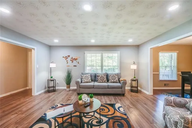 a living room with furniture and wooden floor