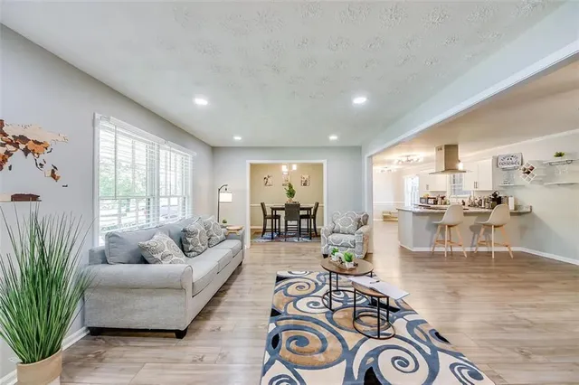 a living room with furniture and a large window
