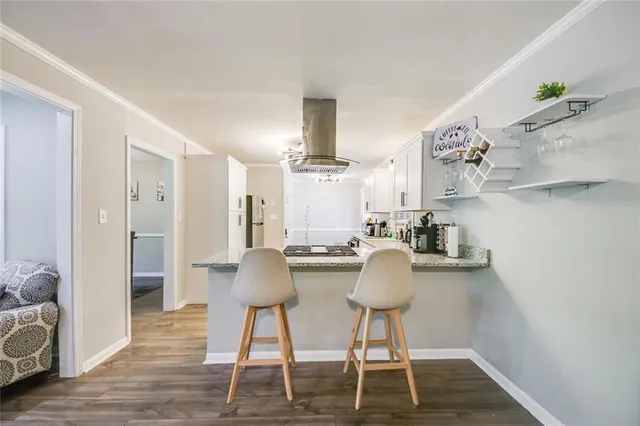 a dining room with furniture and wooden floor