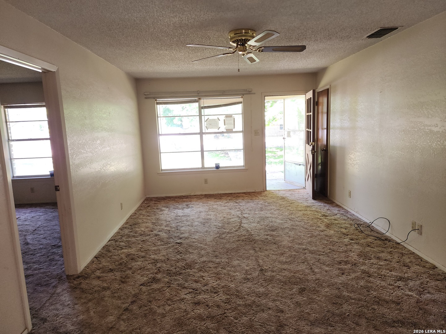 235 North 12th Street Junction, TX 76849 - Photo 10 of 14 en empty room with windows and ceiling fan