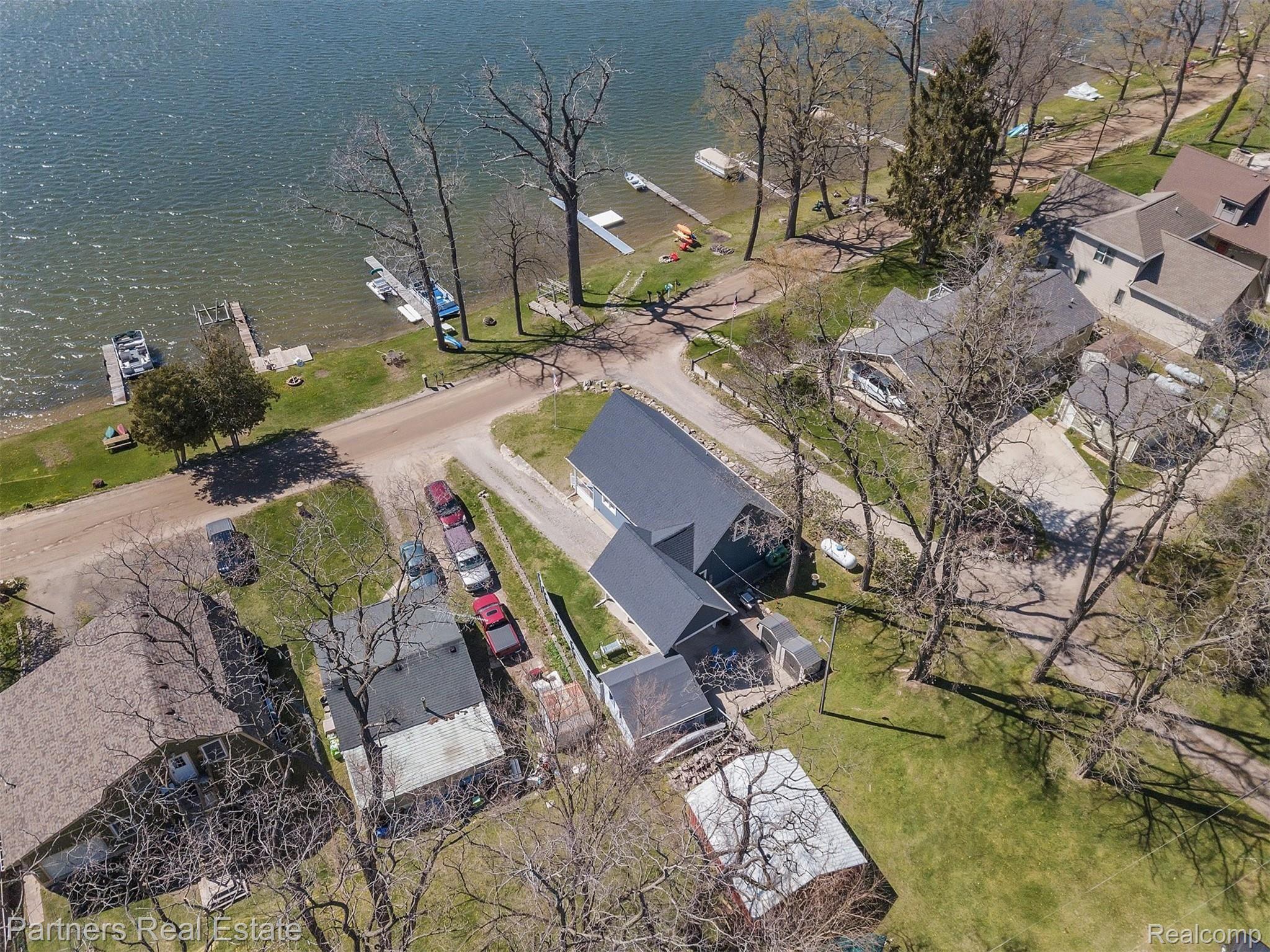 16051 Murray Road Byron, MI 48418 - Photo 9 of 41 View of the back of the home facing McKane Lake.