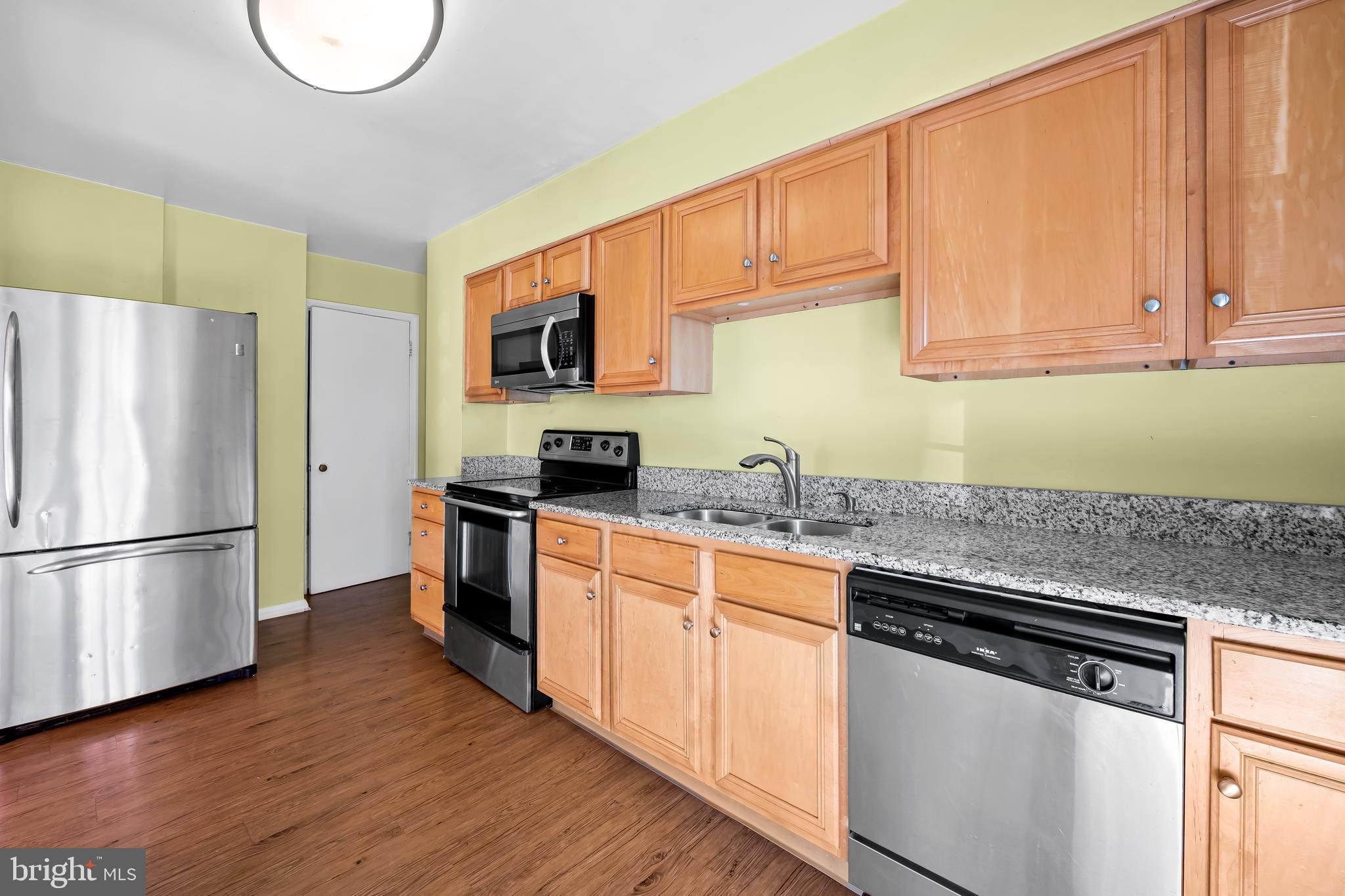 1027 Evesham Avenue Baltimore, MD 21212 - Photo 13 of 39 a kitchen with stainless steel appliances granite countertop a refrigerator sink and cabinets