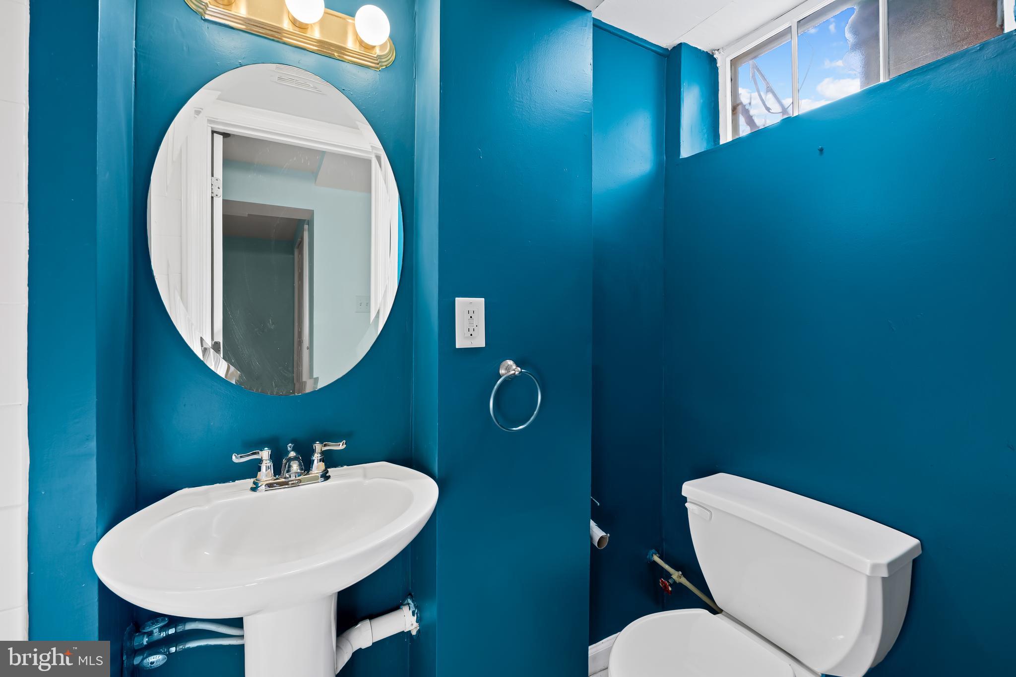 1027 Evesham Avenue Baltimore, MD 21212 - Photo 21 of 39 a bathroom with a toilet sink and mirror