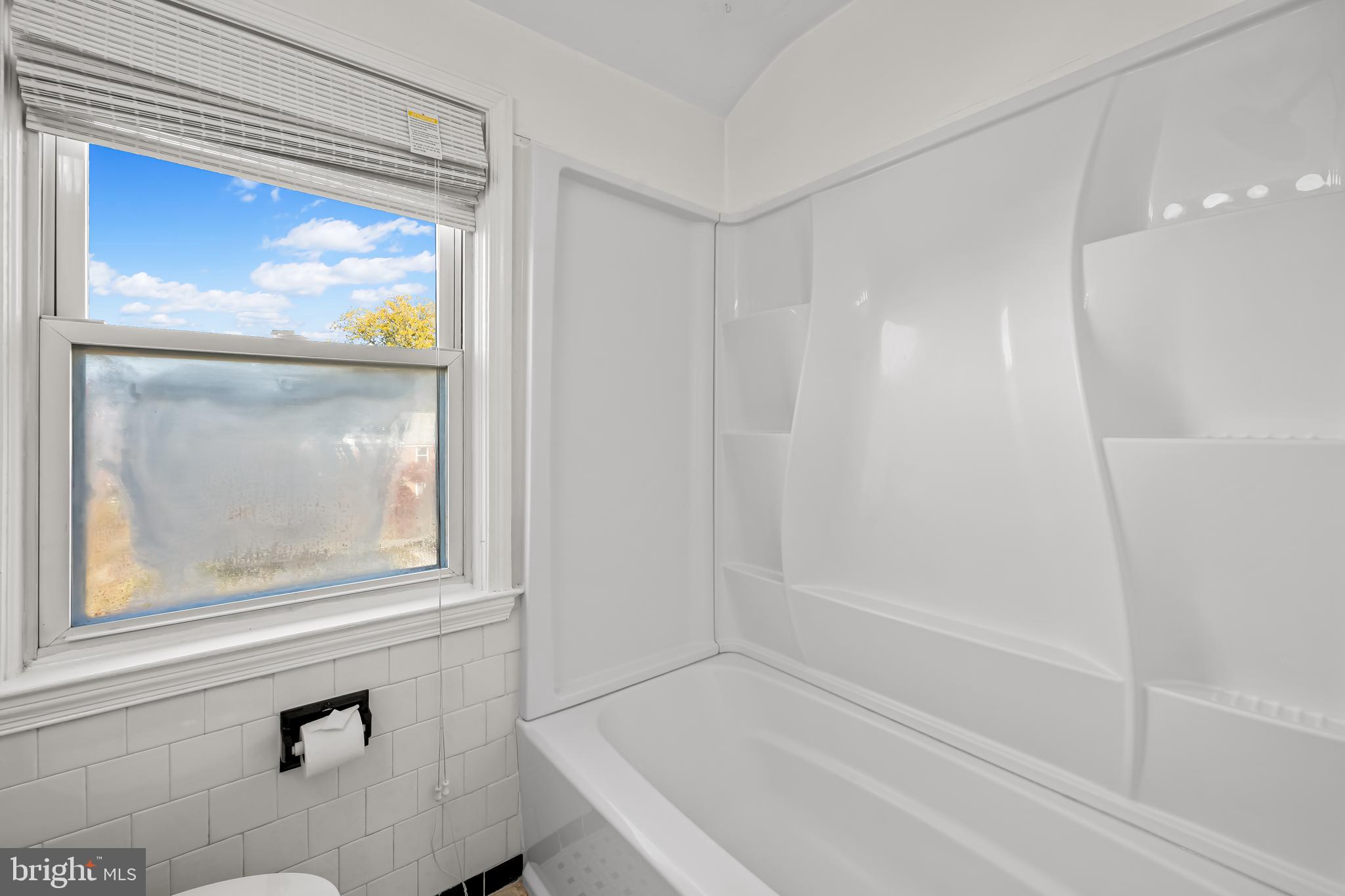 1027 Evesham Avenue Baltimore, MD 21212 - Photo 23 of 39 a bathroom with a bathtub and a shower